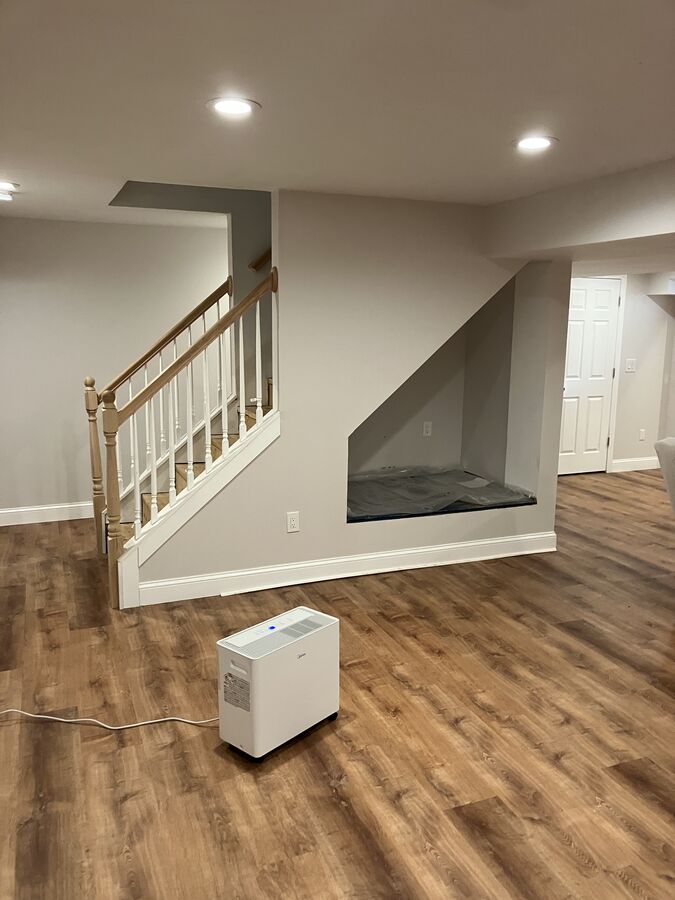Finished basement — staircase, under-stair nook, recessed lighting, LVP flooring
