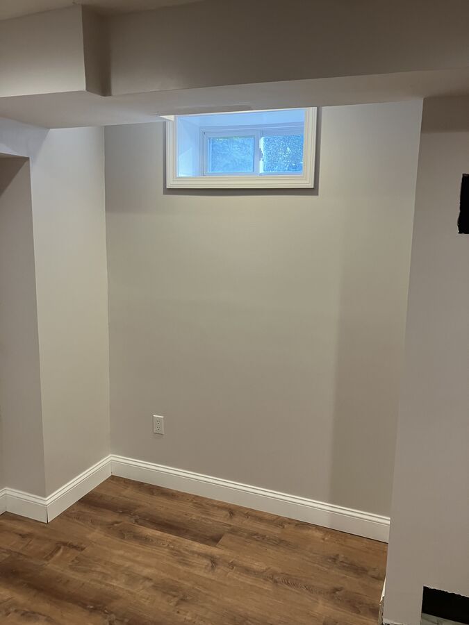 Finished basement — window alcove with framing detail, baseboard trim
