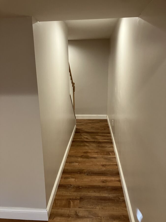 Finished basement — looking down staircase, flooring carried through