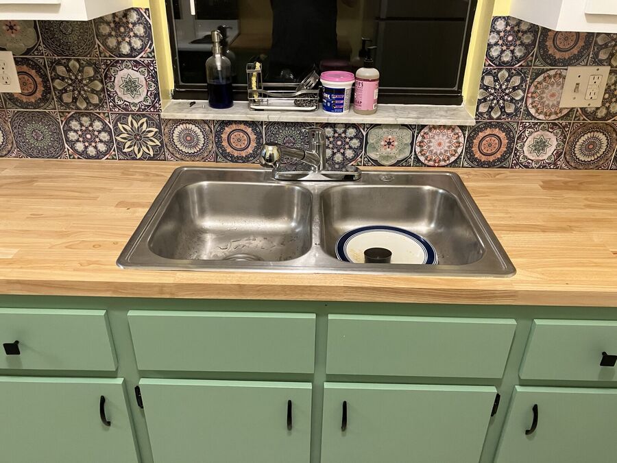 Backsplash detail — decorative Mediterranean tile with butcher block counter