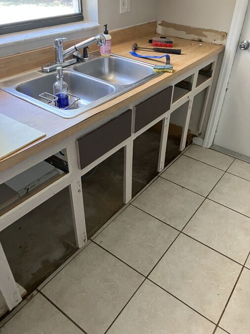 Kitchen sink area before refresh — backsplash removed